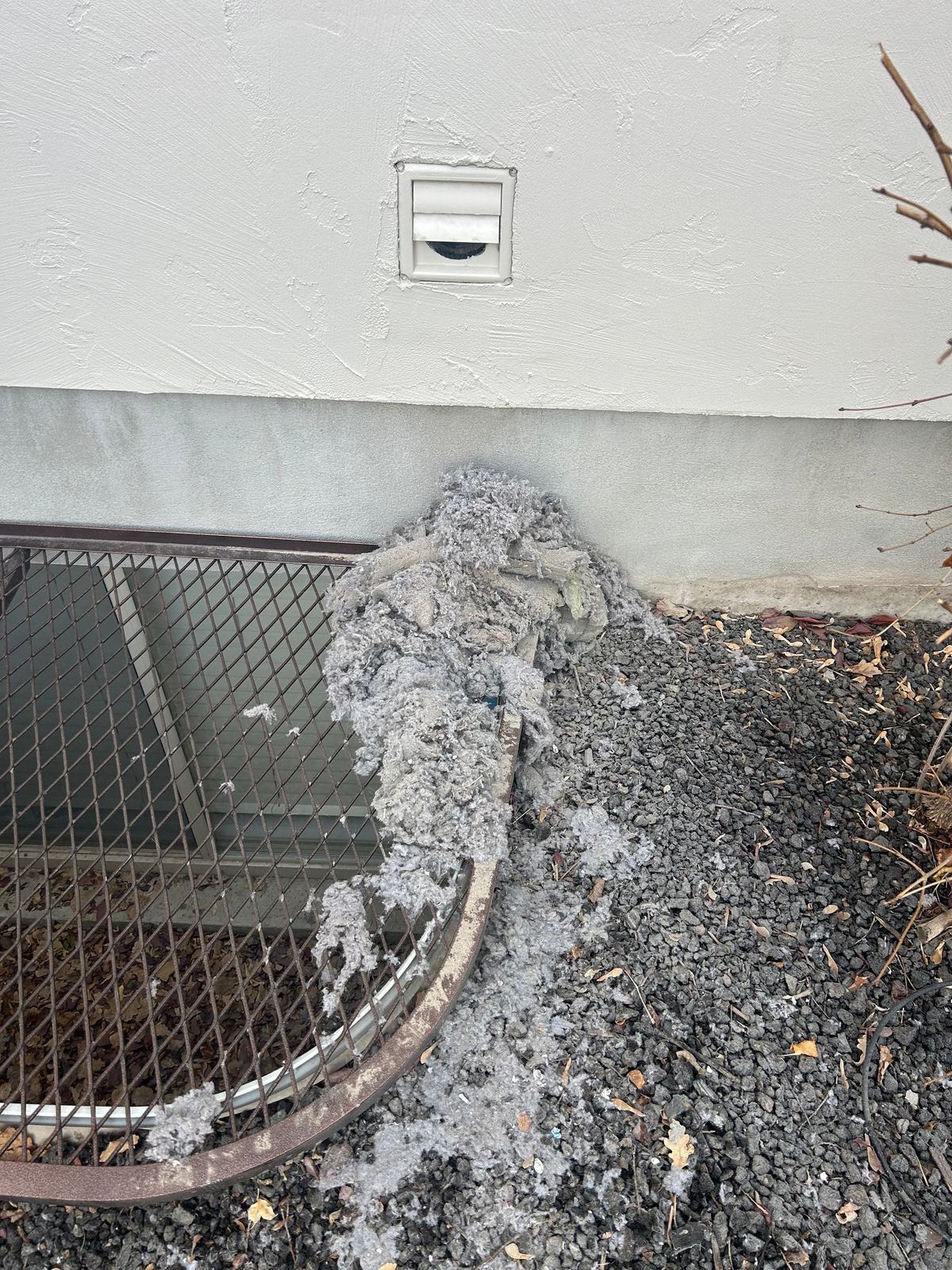 Before: Dryer vent — lint piling up under a clogged wall vent